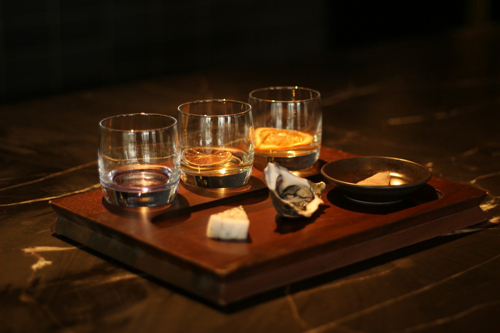 A selection of the best whiskey tasting kits uk displayed on a wooden bar top