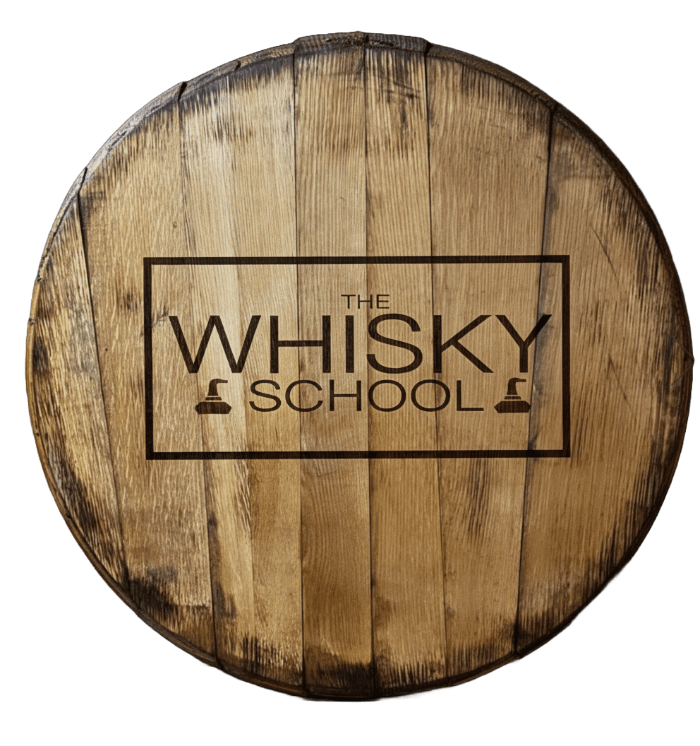 A rustic wooden whisky barrel head featuring The Whisky School logo branded into the wood with a charred, heat-treated rectangular border.