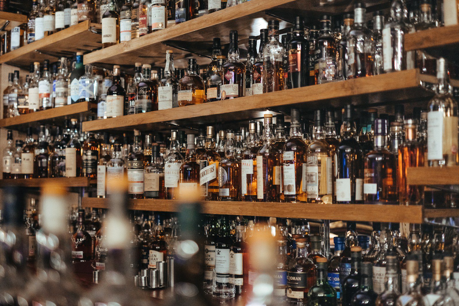 A curated whisky collection on a home bar shelf