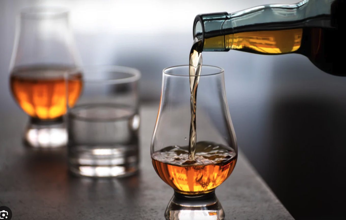 Glass of Non-Chill Filtered whisky showing natural cloudy haze