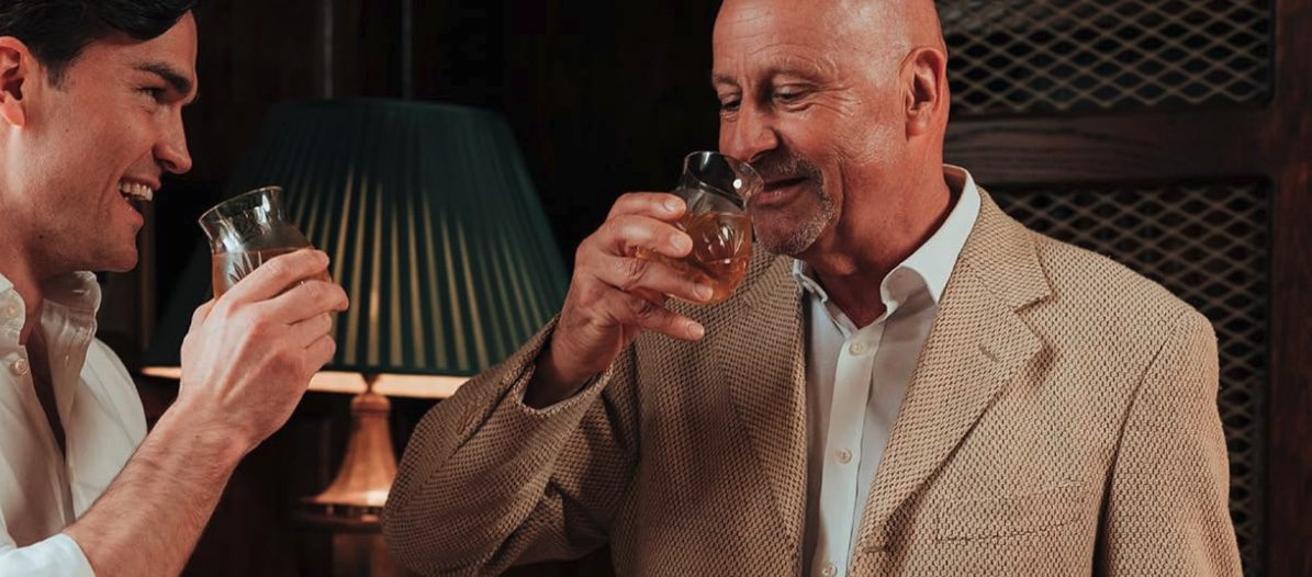Someone learning how to taste whisky using a professional nosing glass