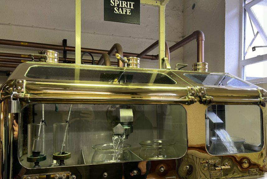 A brass spirit safe showing the whisky distillation cuts