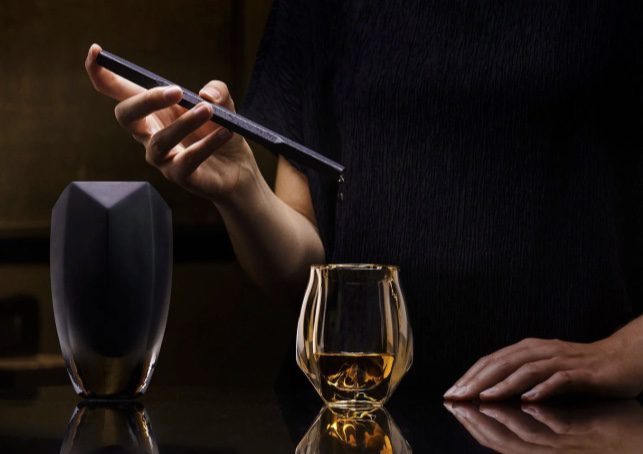 A glass whisky water dropper adding a single drop to a dram
