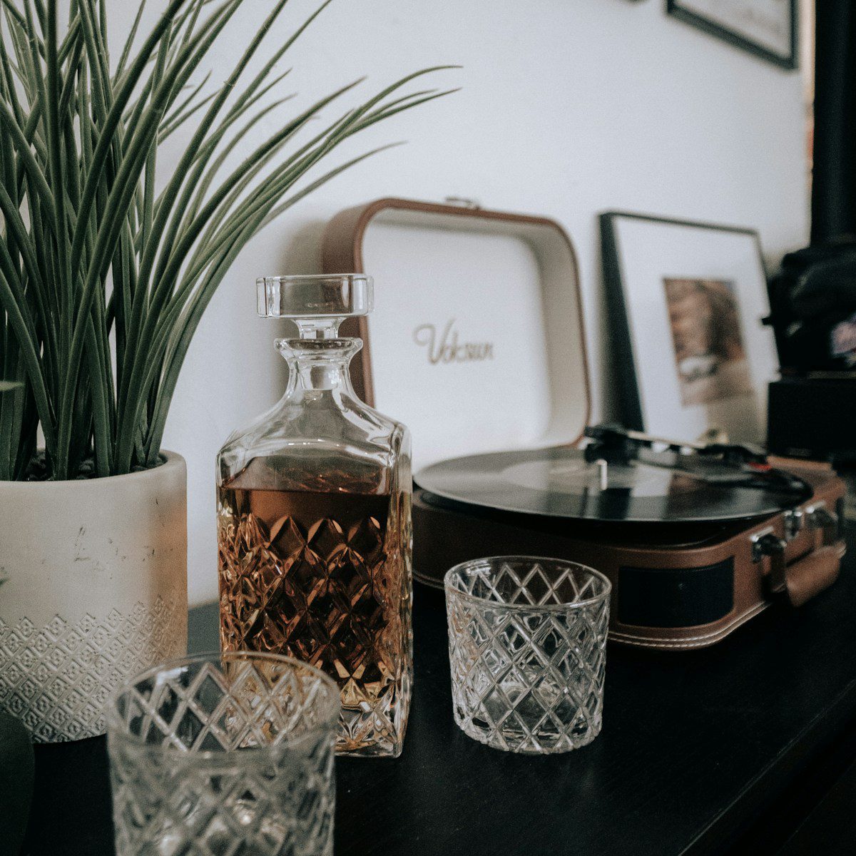 Crystal whisky decanter filled with bourbon on a table