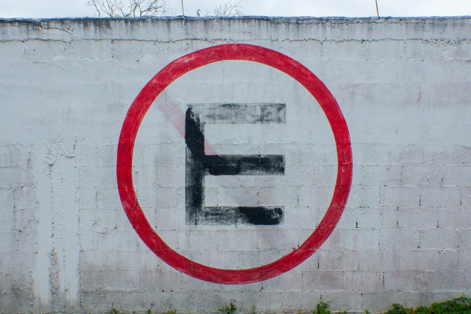 Letter E In black paint with red circle