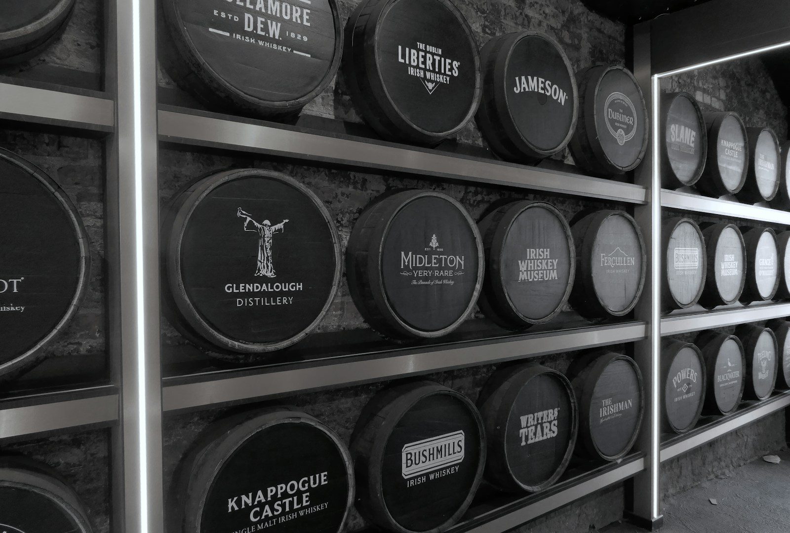 Collection of rare whisky investment bottles on a dark shelf