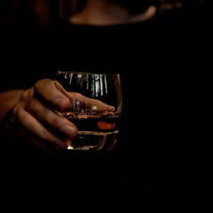 person holding a glass of whisky ready to taste. this is the start of whisky tasting 101