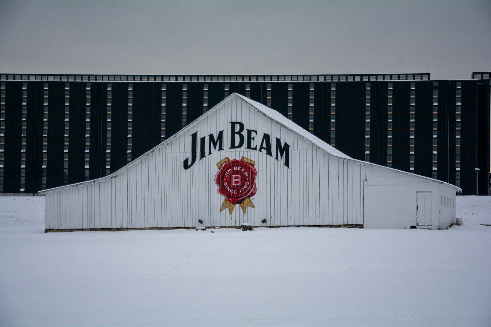 A bourbon enthusiast demonstrating the Kentucky Chew method during a tasting